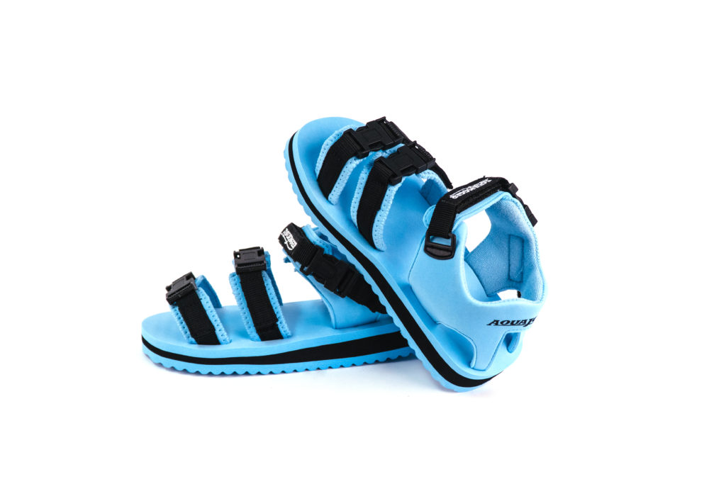 Aqua jogger exer sandal, left pair on ground, right pair leaning against left pair facing up.