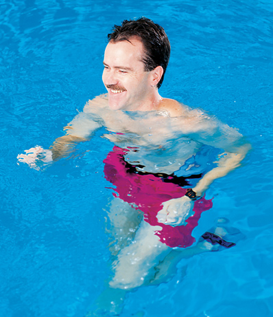 Man's head above water in pool wearing aqua jogger belt and aqua runners.